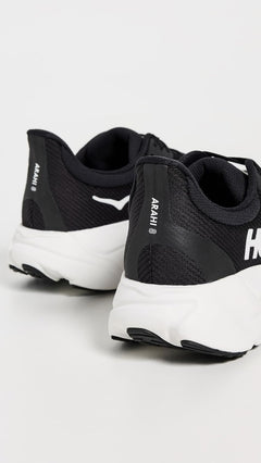 Hoka men's Arahi 8 hiking shoes in black with orange accents, featuring durable rocky outsole and supportive hiking footwear design.