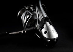 Okuma Coronado CDX saltwater baitfeeder reel mounted on fishing rod, showing spool and handle for saltwater fishing.